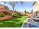 Lush backyard featuring synthetic grass, patio seating, and decorative landscaping for outdoor enjoyment at 7505 Mission Palm St, Las Vegas, NV 89139