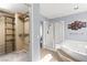 Bathroom featuring a soaking tub, separate glass shower and walk-in closet at 7505 Mission Palm St, Las Vegas, NV 89139