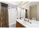 Full bath shows shower over tub and single sink vanity at 7505 Mission Palm St, Las Vegas, NV 89139