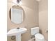 Neutral toned powder room featuring a pedestal sink and low-flow toilet at 7505 Mission Palm St, Las Vegas, NV 89139