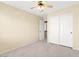 This bedroom features a neutral color scheme, ceiling fan, and a closet at 7505 Mission Palm St, Las Vegas, NV 89139