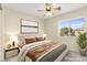 This staged bedroom features a neutral color scheme, large window, and stylish decor at 7505 Mission Palm St, Las Vegas, NV 89139