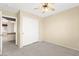 This bedroom features a neutral color scheme, ceiling fan, and a closet at 7505 Mission Palm St, Las Vegas, NV 89139