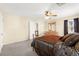 Cozy bedroom features a ceiling fan, neutral walls, and a comfortable bed with decorative pillows at 7505 Mission Palm St, Las Vegas, NV 89139