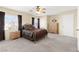 Carpeted bedroom features large window, ceiling fan and nice closet at 7505 Mission Palm St, Las Vegas, NV 89139