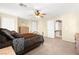 Carpeted bedroom shows large window, ceiling fan and ensuite bath at 7505 Mission Palm St, Las Vegas, NV 89139