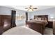 Comfortable bedroom features a ceiling fan, plush carpet, and a window view at 7505 Mission Palm St, Las Vegas, NV 89139
