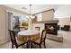 Dining area adjacent to the fireplace featuring a table with backyard views at 7505 Mission Palm St, Las Vegas, NV 89139