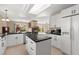 Modern kitchen with stainless steel appliances, white cabinetry and a center island with a dark countertop at 7505 Mission Palm St, Las Vegas, NV 89139