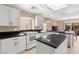 Kitchen featuring white cabinets, a central island, and tile flooring throughout at 7505 Mission Palm St, Las Vegas, NV 89139