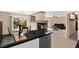 Open floorplan with a black granite countertop, fireplace, and dining area with backyard views at 7505 Mission Palm St, Las Vegas, NV 89139