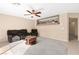 Spacious living room features cozy seating and a central table on the tile floor at 7505 Mission Palm St, Las Vegas, NV 89139