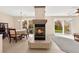 Open-concept living and dining space featuring tile floors and a charming fireplace at 7505 Mission Palm St, Las Vegas, NV 89139