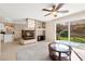Living room with tile floors, central fireplace, and access to the outdoor patio at 7505 Mission Palm St, Las Vegas, NV 89139