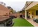 A backyard view with hot tub, patio, and artificial grass, creating an ideal outdoor retreat at 7553 Old Compton St, Las Vegas, NV 89166