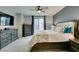 Spacious bedroom with elegant furnishings, carpet, and a sliding glass door to the outside at 7553 Old Compton St, Las Vegas, NV 89166