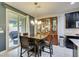 Dining area with a wooden table and chairs, adjacent to the kitchen with access to the backyard at 7553 Old Compton St, Las Vegas, NV 89166