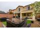 Backyard featuring a hot tub, patio area, and lush greenery, offering a private outdoor oasis at 7553 Old Compton St, Las Vegas, NV 89166