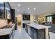 Modern kitchen with stainless steel appliances, a center island, and an open layout leading to the dining area at 7553 Old Compton St, Las Vegas, NV 89166
