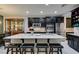 A well-equipped kitchen featuring black cabinetry, stainless steel appliances, and a white marble island at 7553 Old Compton St, Las Vegas, NV 89166