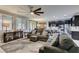 Comfortable living room with plush sofas, a patterned rug, and a ceiling fan for added comfort at 7553 Old Compton St, Las Vegas, NV 89166