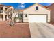 Inviting front exterior featuring a well-maintained lawn, mature trees, and a two-car garage at 7628 Picnic St, Las Vegas, NV 89131