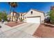 Charming home with a two-car garage, lush landscaping, and a well-maintained front yard at 7628 Picnic St, Las Vegas, NV 89131