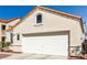 Home featuring a two-car garage and manicured front yard, showcasing curb appeal at 7628 Picnic St, Las Vegas, NV 89131
