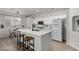 Open kitchen featuring an island, white cabinets, and modern fixtures at 7628 Picnic St, Las Vegas, NV 89131