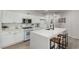 Bright kitchen with white cabinets, an island with seating, and modern appliances at 7628 Picnic St, Las Vegas, NV 89131