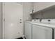 Bright laundry room equipped with a white washer and dryer set and ample shelving at 7628 Picnic St, Las Vegas, NV 89131