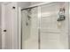 Modern shower with glass doors, a built-in seat, and sleek fixtures at 7628 Picnic St, Las Vegas, NV 89131