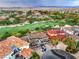 Expansive aerial view showcases the golf course community and nearby mountains at 8 Rue Du Ville Way, Henderson, NV 89011