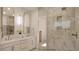 Jack and Jill bathroom features double sinks, white marble countertops and shower with neutral colored tile surround at 8 Rue Du Ville Way, Henderson, NV 89011