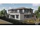 Side view of modern home, landscaped backyard, windows, and a balcony, showcasing architectural details and outdoor living space at 8 Rue Du Ville Way, Henderson, NV 89011