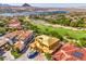 Aerial view of home under construction, showcasing the tile roof, solar panels, and surrounding neighborhood near a lake at 8 Rue Du Ville Way, Henderson, NV 89011