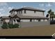 Modern two-story home showcasing a tile roof, stone accents, a three-car garage, desert landscaping, and a private backyard at 8 Rue Du Ville Way, Henderson, NV 89011