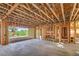 Spacious, unfinished garage with a concrete floor, exposed wooden beams and an open doorway at 8 Rue Du Ville Way, Henderson, NV 89011