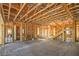Unfinished interior with exposed wooden beams, wood framing, and a staircase to the second story at 8 Rue Du Ville Way, Henderson, NV 89011