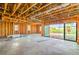Bright interior space with exposed framing, concrete floor, and large sliding glass doors leading to the outdoors at 8 Rue Du Ville Way, Henderson, NV 89011