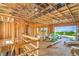 Unfinished interior with exposed wooden beams, a staircase, and large sliding glass doors at 8 Rue Du Ville Way, Henderson, NV 89011