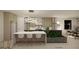 Modern kitchen featuring a waterfall island, sleek cabinetry and contemporary lighting at 8 Rue Du Ville Way, Henderson, NV 89011
