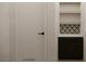 The laundry room features dark wood cabinets, marble countertops and two wood shelves at 8 Rue Du Ville Way, Henderson, NV 89011