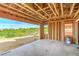 Open-concept living room with exposed framing and an expansive view of the outdoor greenery at 8 Rue Du Ville Way, Henderson, NV 89011