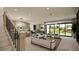 Open-concept living room with modern furnishings, an open kitchen and large windows that provide abundant natural light at 8 Rue Du Ville Way, Henderson, NV 89011