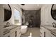 Modern primary bathroom with dual vanities, soaking tub, and a spacious walk-in shower with sleek tile work at 8 Rue Du Ville Way, Henderson, NV 89011