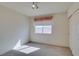 Bright bedroom with neutral carpet, closet, and a sunlit window with decorative valance at 8012 Pottery Creek Dr, Las Vegas, NV 89128