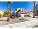 Attractive two-story home boasting a lush front yard, two-car garage and mature palm trees at 8012 Pottery Creek Dr, Las Vegas, NV 89128