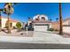 Charming two-story home with a well-maintained front yard and an attached two-car garage at 8012 Pottery Creek Dr, Las Vegas, NV 89128