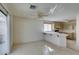 Kitchen area leading to a sliding glass door, bright lighting and wooden cabinets at 8012 Pottery Creek Dr, Las Vegas, NV 89128